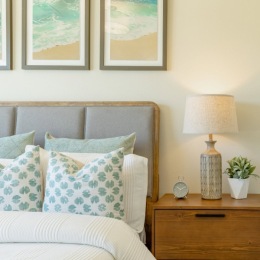 a bedroom with bed side table and lamp