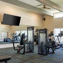 gym with exercise equipment and tv