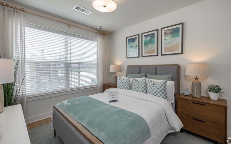 a bedroom with a bed and lamps