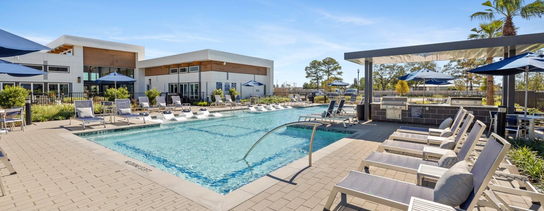 a swimming pool with chairs around it