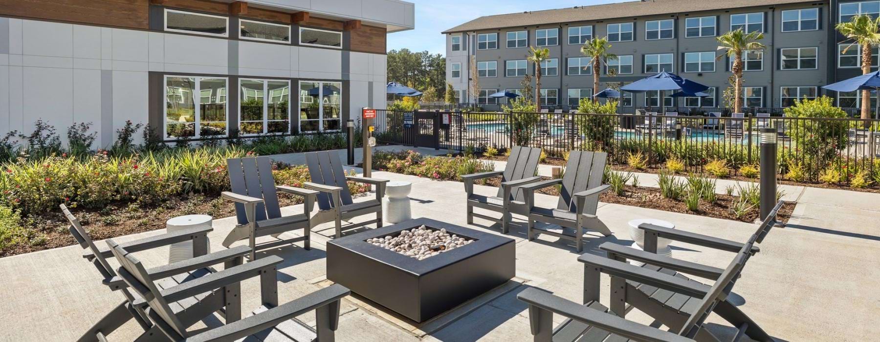 a patio with chairs and tables outside a building