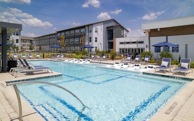 a swimming pool with chairs around it